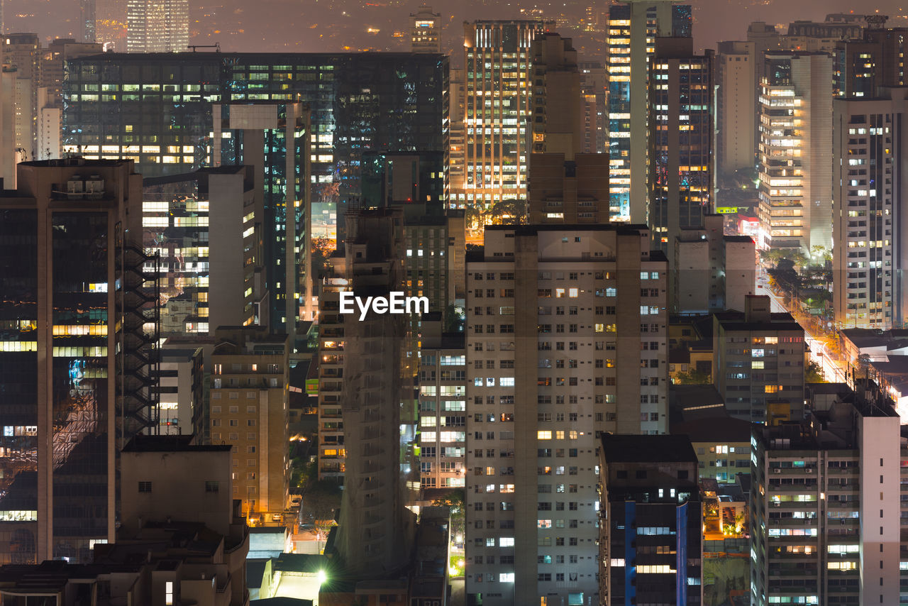 Aerial view of illuminated buildings in city at night