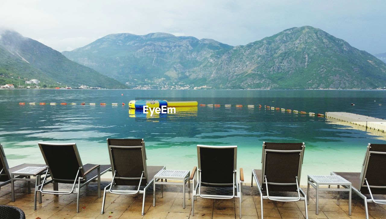 Sun loungers in row overlooking calm sea