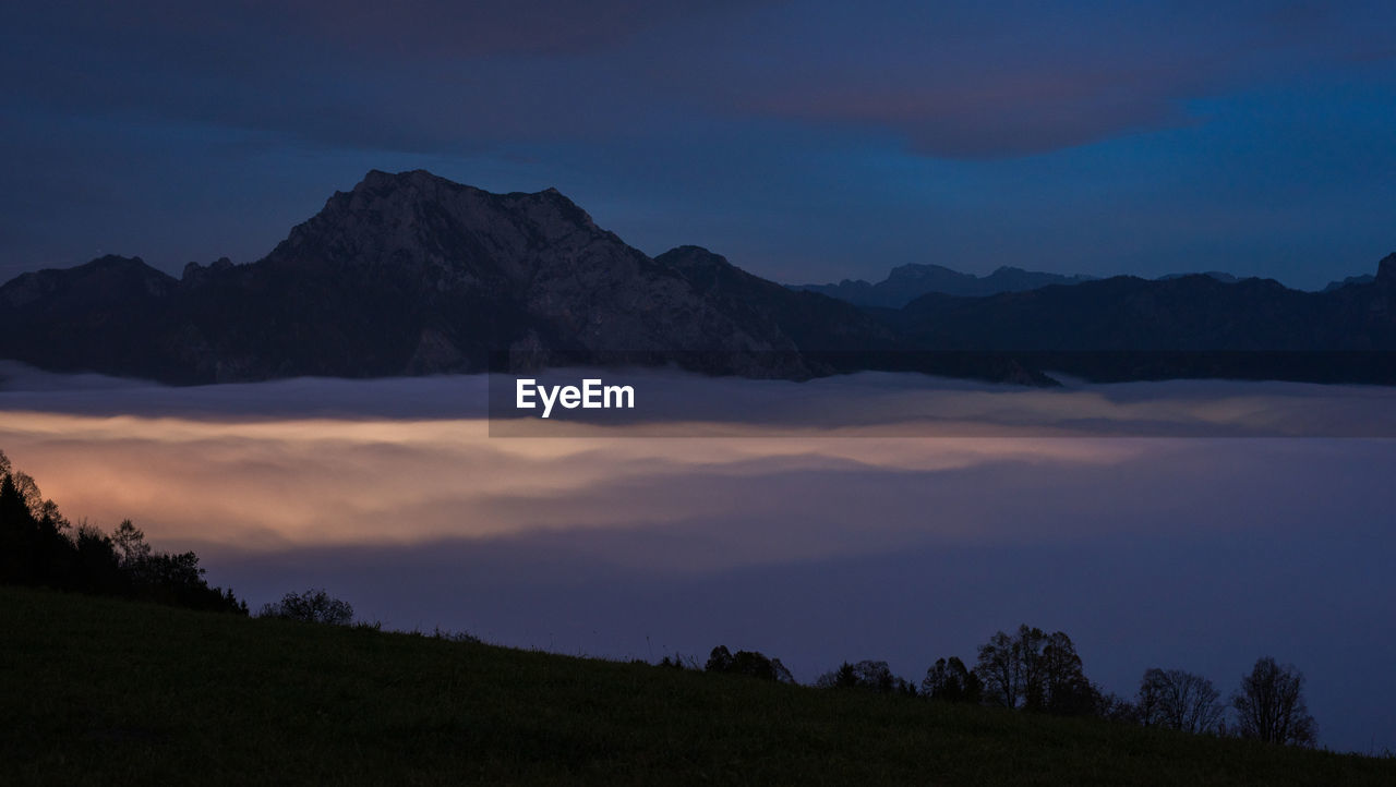 Scenic view of silhouette mountains against sky at sunset