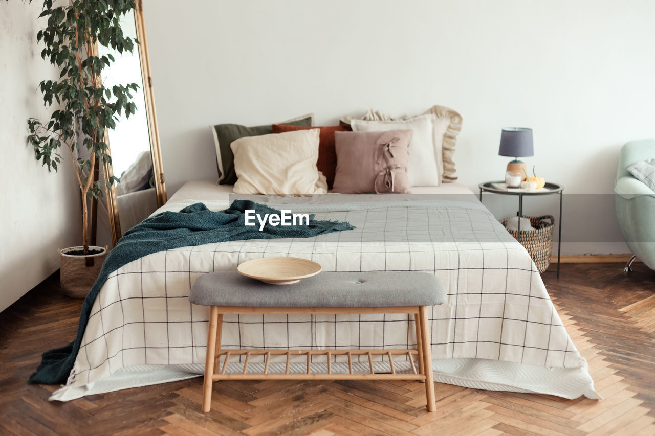 Table and chairs on bed against wall at home