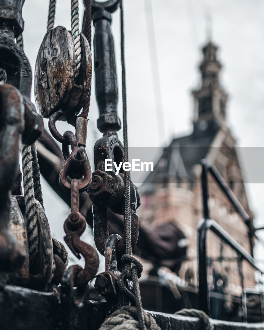 Close-up of rusty chain against sky