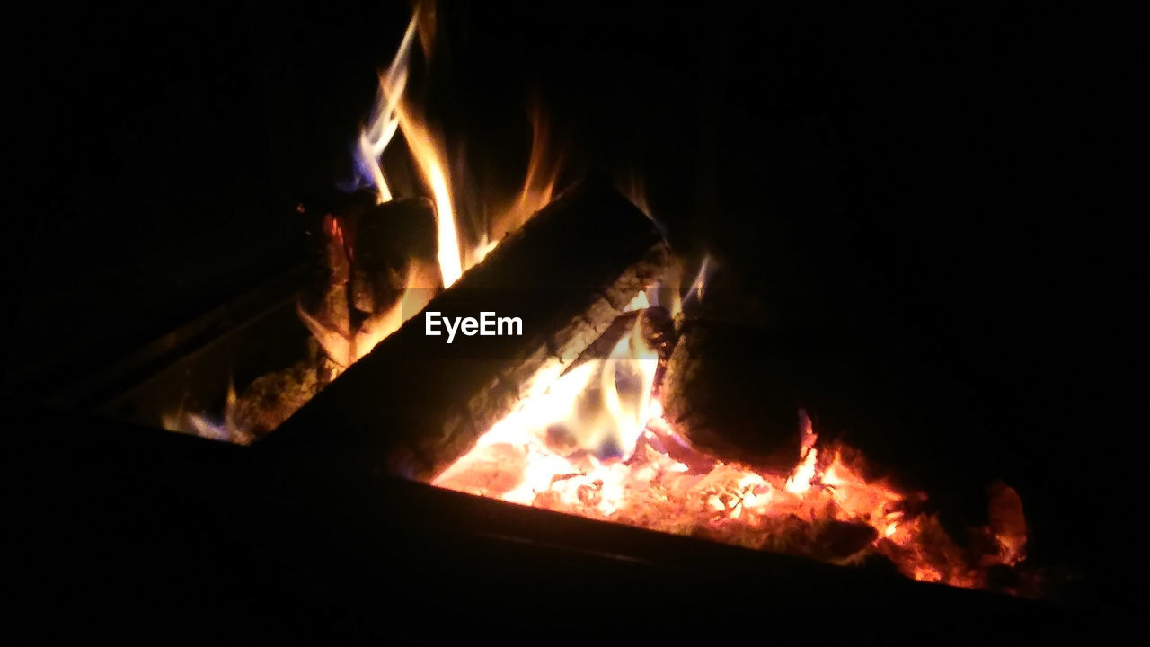 CLOSE-UP OF BONFIRE IN THE DARK