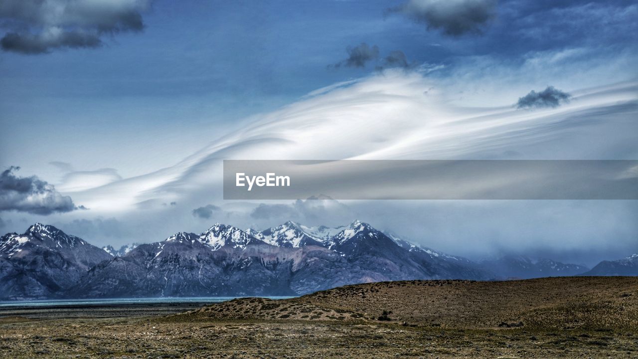 IDYLLIC SHOT OF SNOWCAPPED MOUNTAINS AGAINST SKY