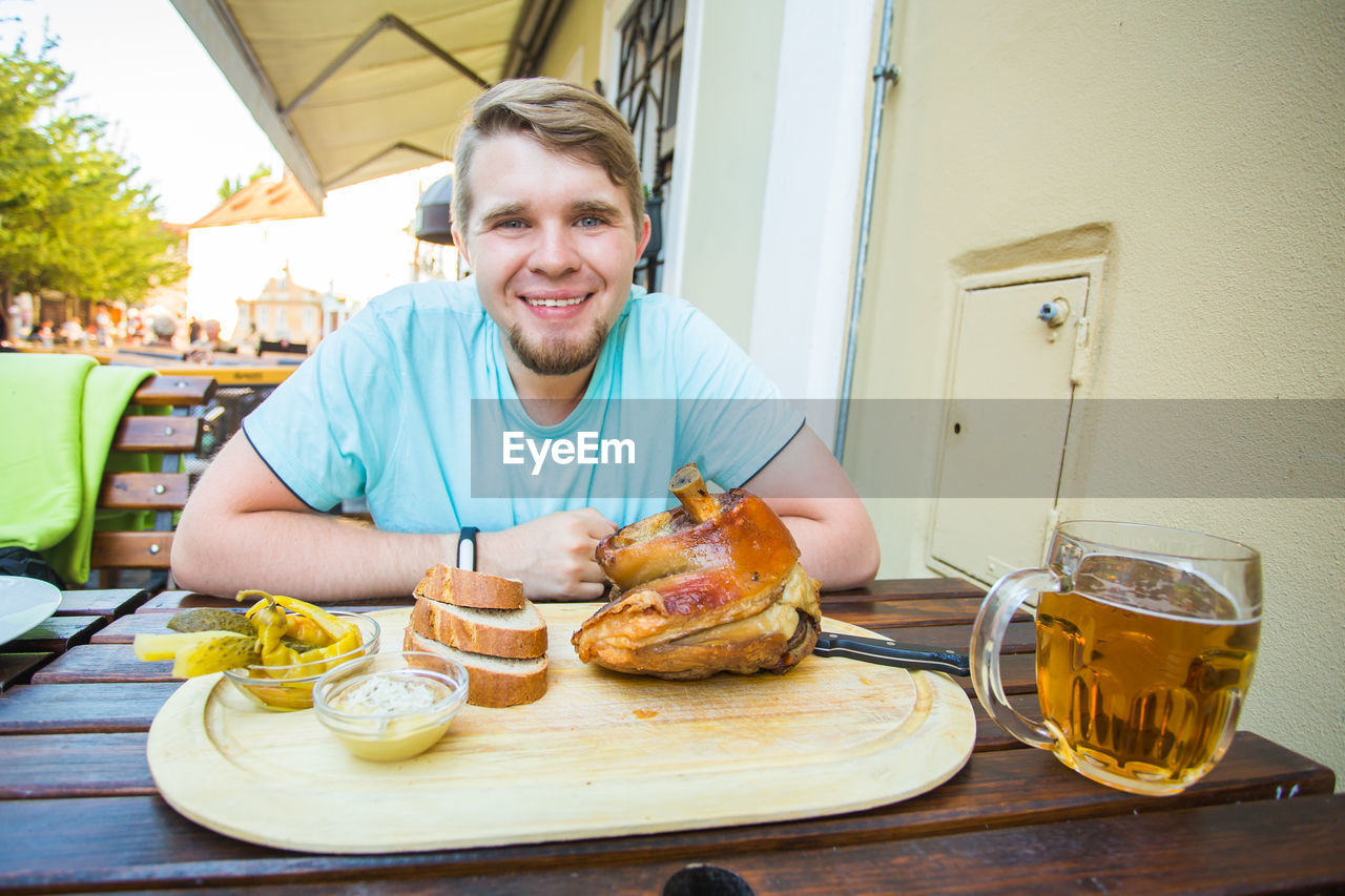 portrait of smiling woman having food at home