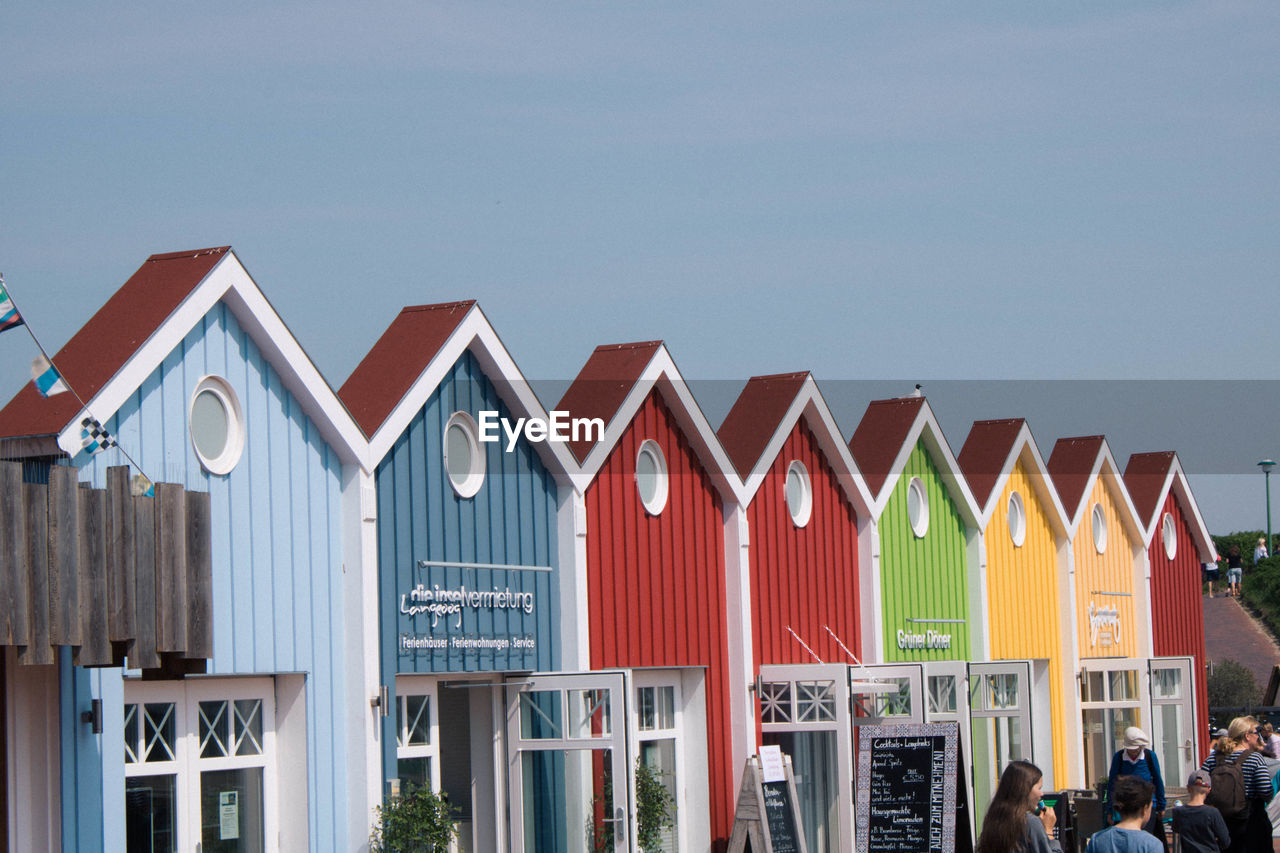 MULTI COLORED HOUSES IN BUILDING AGAINST SKY