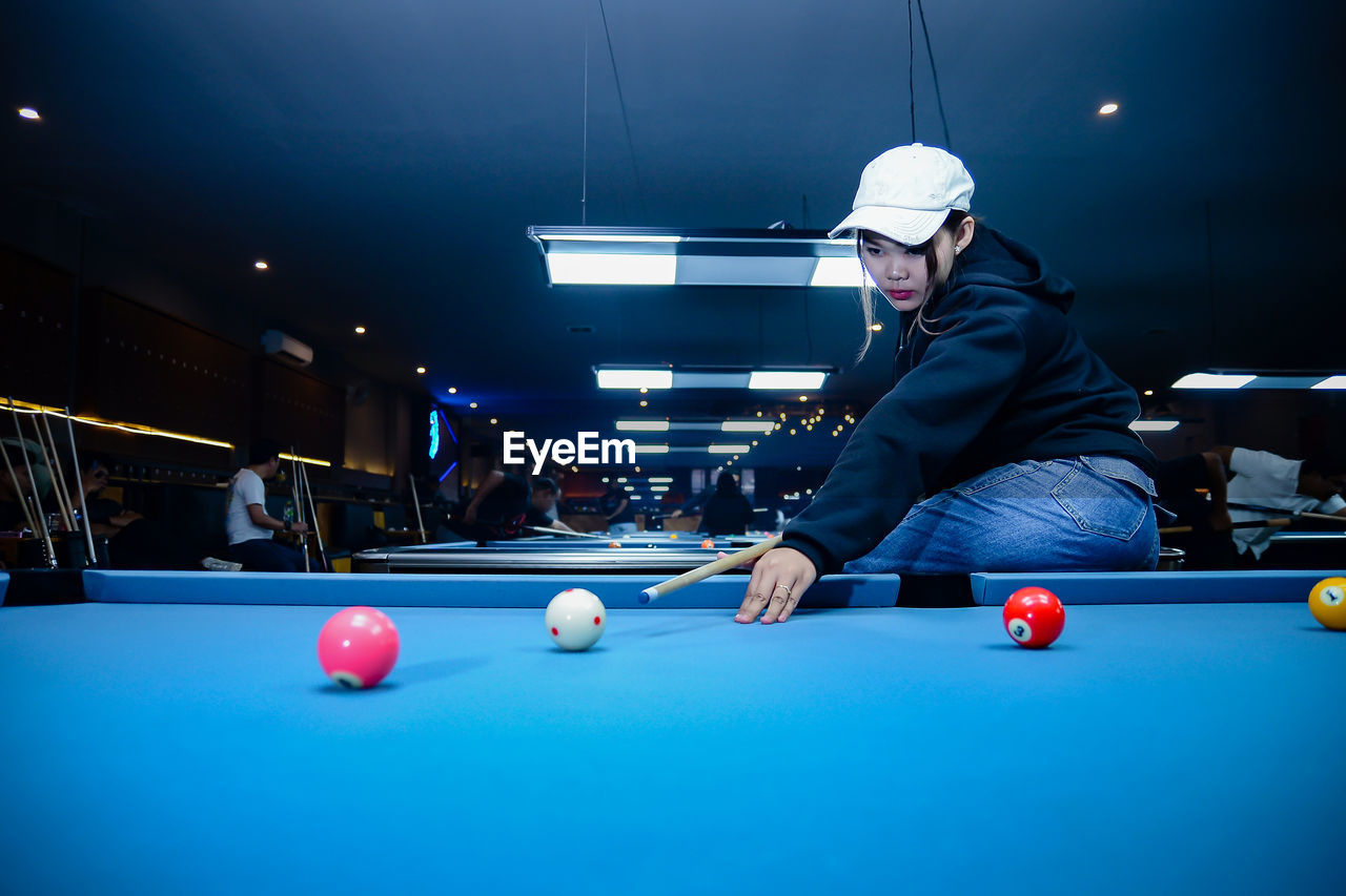 rear view of man playing pool