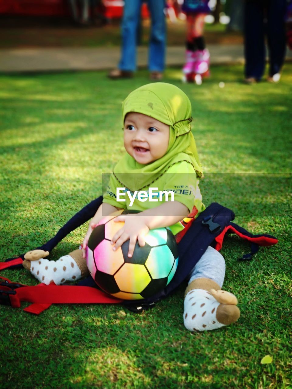 Portrait of cute girl sitting on grass