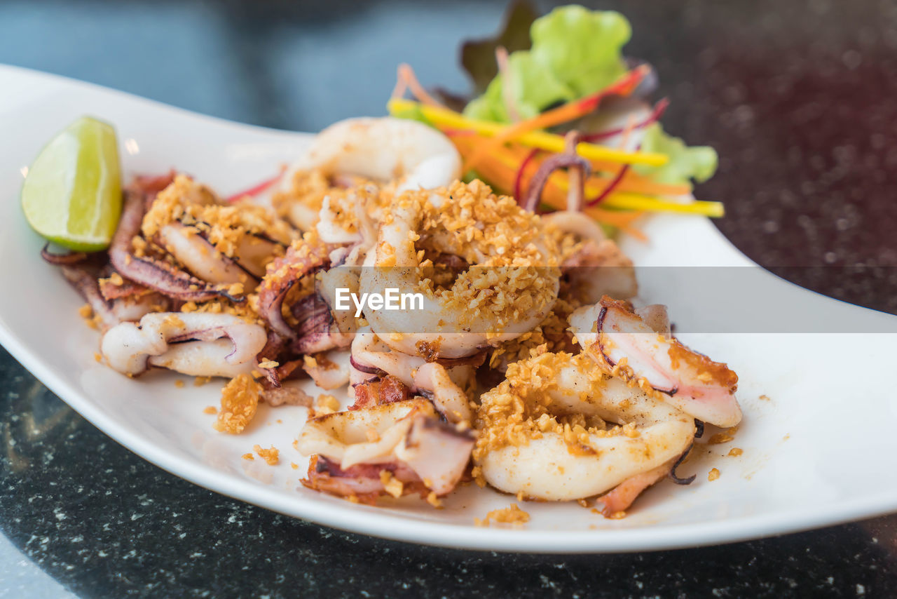 CLOSE-UP OF SERVED FOOD IN PLATE WITH TABLE