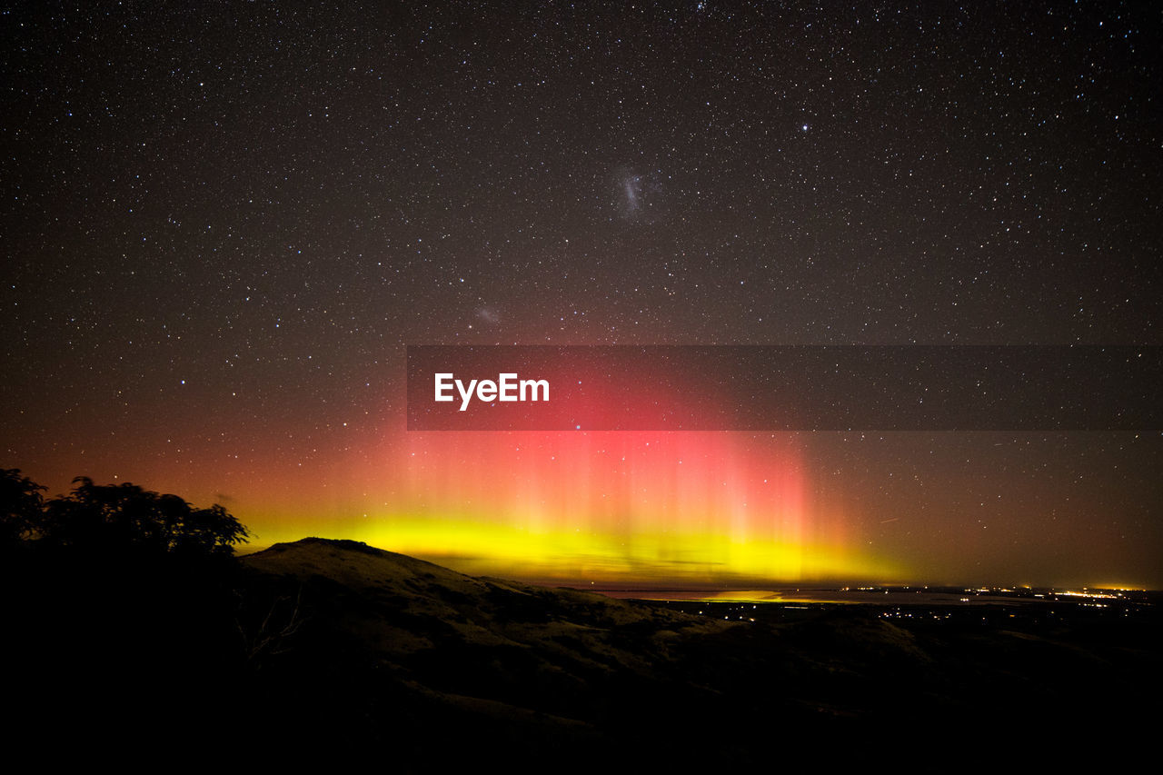 Scenic view of landscape against sky at night