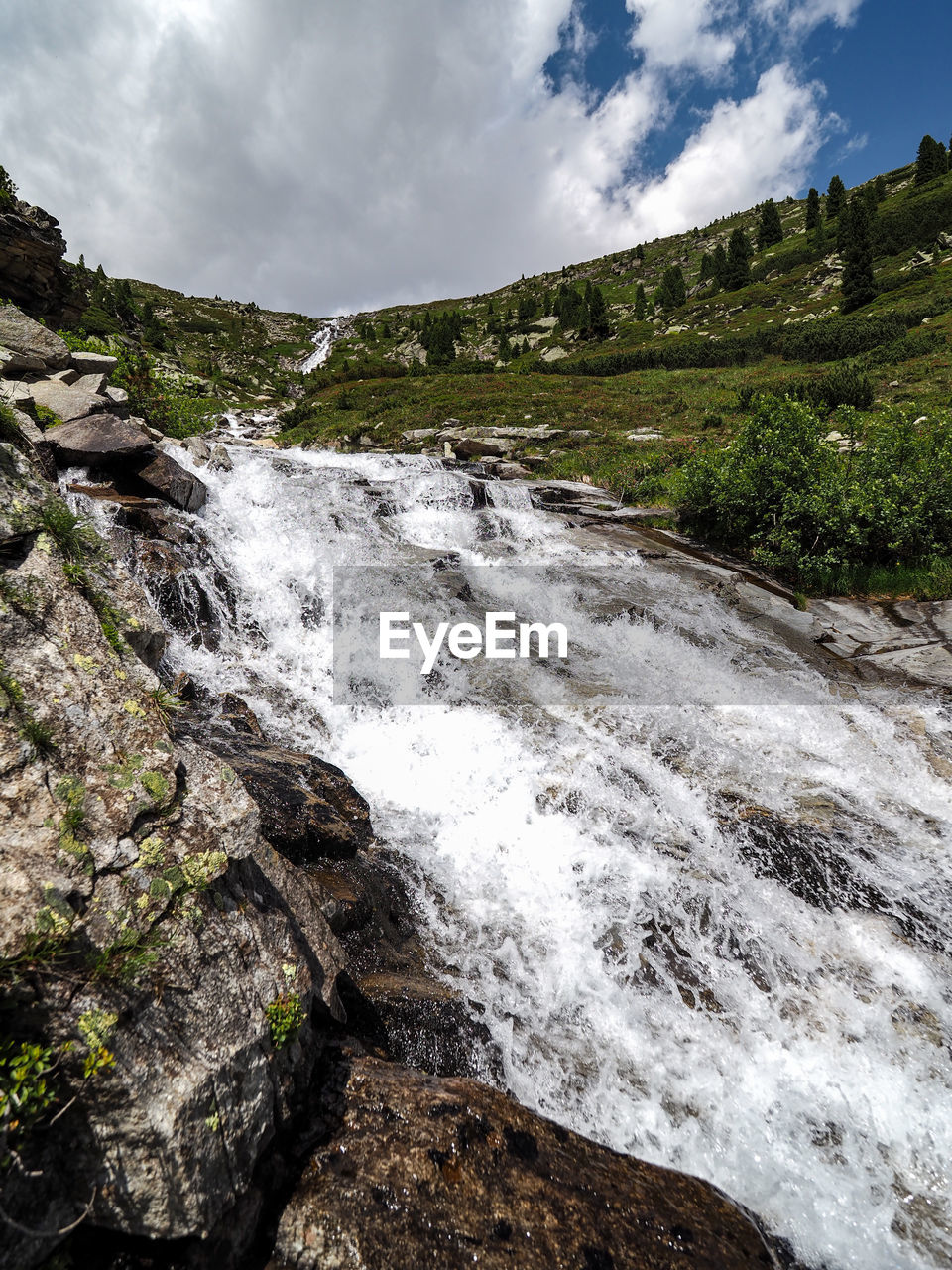 Scenic view of waterfall against sky