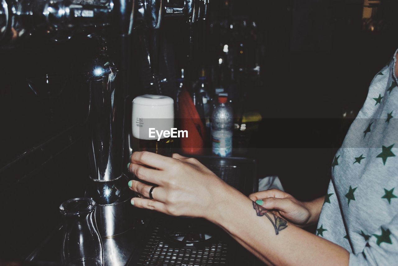 Woman filling a beer glass