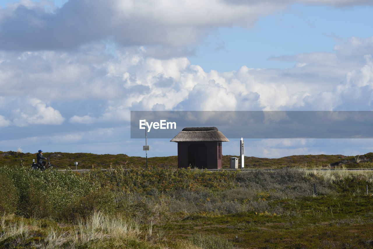 sky, cloud, rural area, built structure, architecture, hill, environment, nature, landscape, grass, land, horizon, building exterior, prairie, tower, plant, no people, wind, field, day, coast, building, sea, outdoors, rural scene, scenics - nature, natural environment, hut, non-urban scene, environmental conservation, beauty in nature, plain, power generation