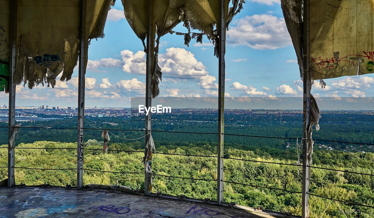 SCENIC VIEW OF SEA AGAINST SKY SEEN THROUGH TREES