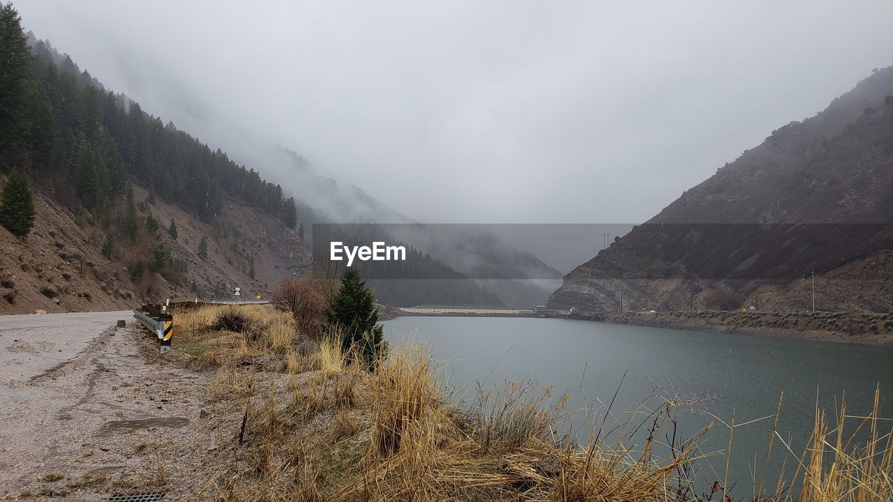 Scenic view of lake and mountains against sky