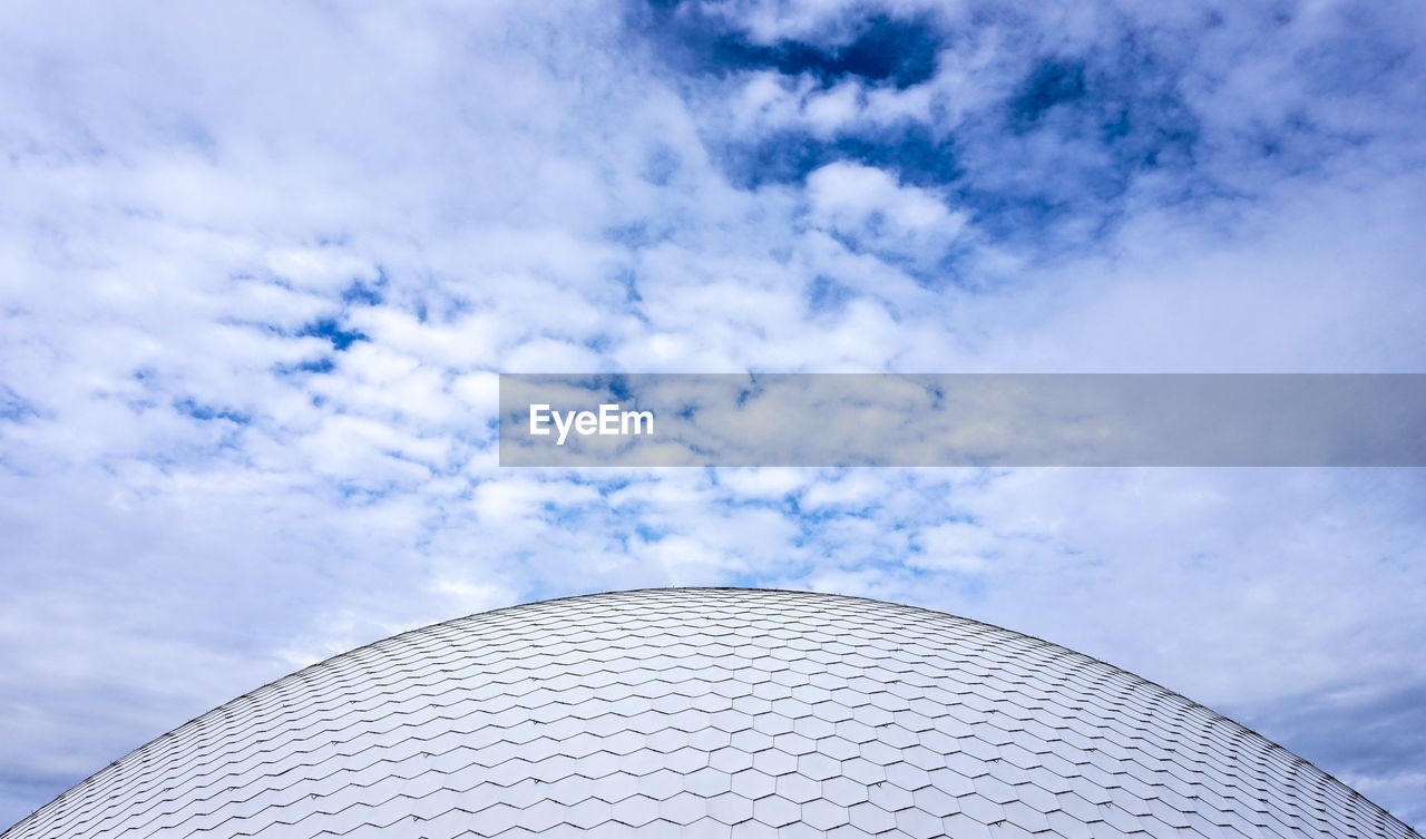 Low angle view of building against cloudy sky