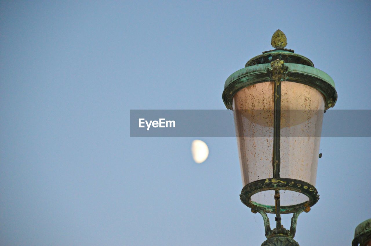 LOW ANGLE VIEW OF MOON AGAINST CLEAR SKY