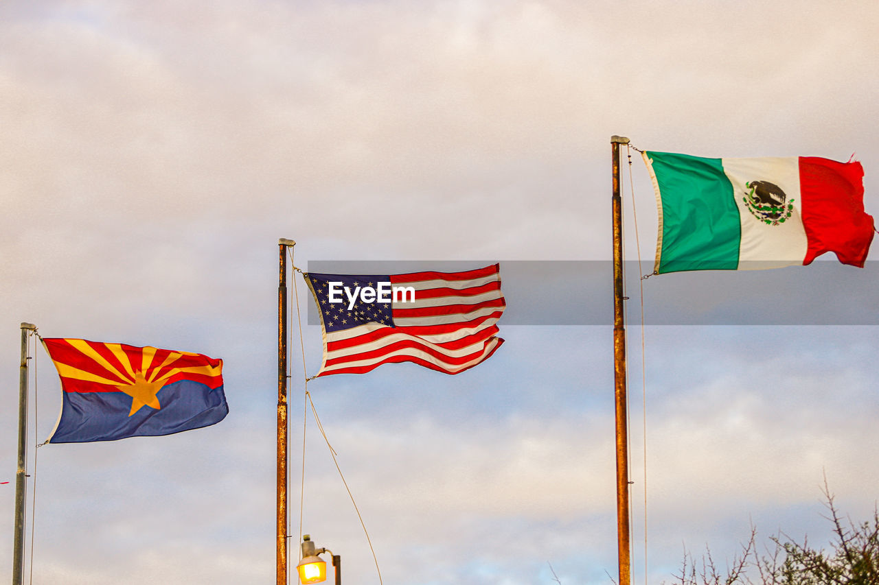 Low angle view of flag against sky, arizona flag, usa flag, mexico flag