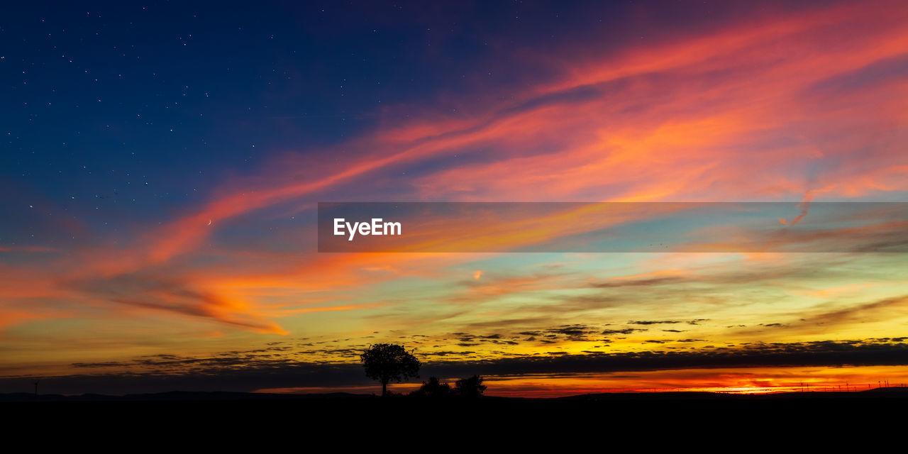 SCENIC VIEW OF SILHOUETTE LANDSCAPE AGAINST DRAMATIC SKY