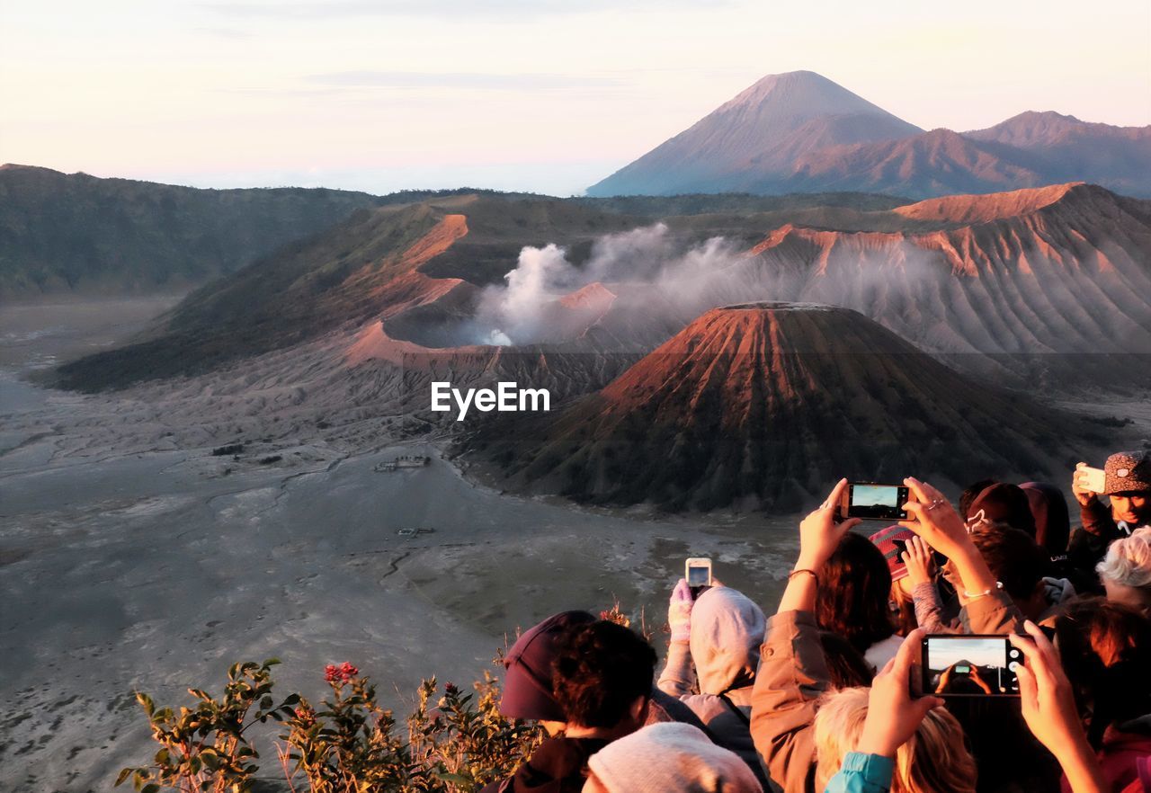 People photographing volcanic landscape