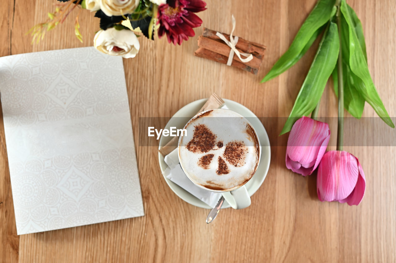 HIGH ANGLE VIEW OF COFFEE CUP ON TABLE AT HOME