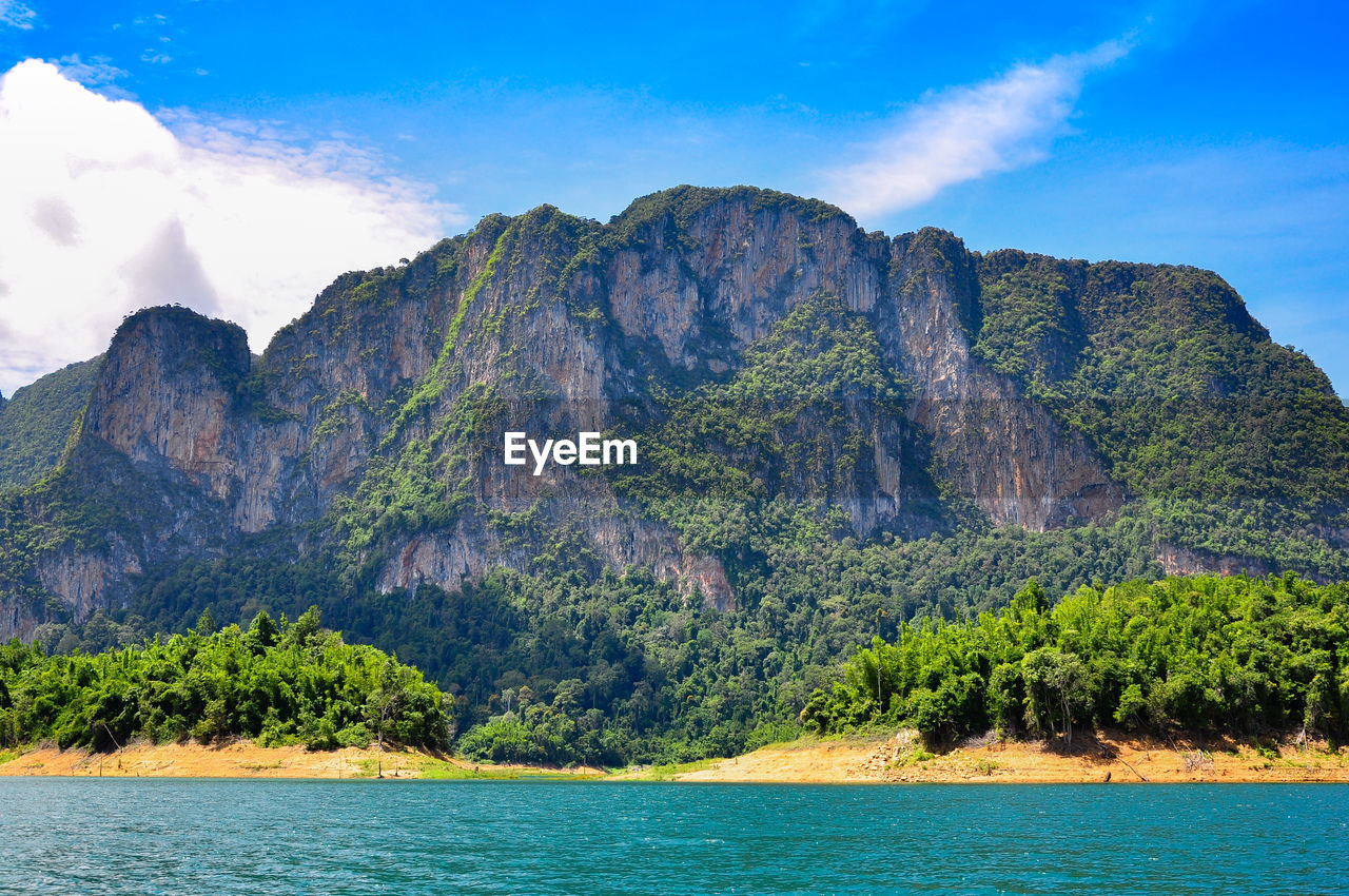 Scenic view of sea and mountains against sky