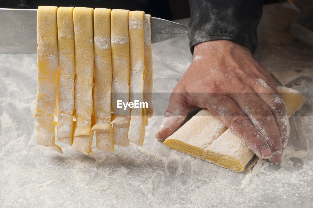 Cropped hands of chef preparing food on table in commercial kitchen