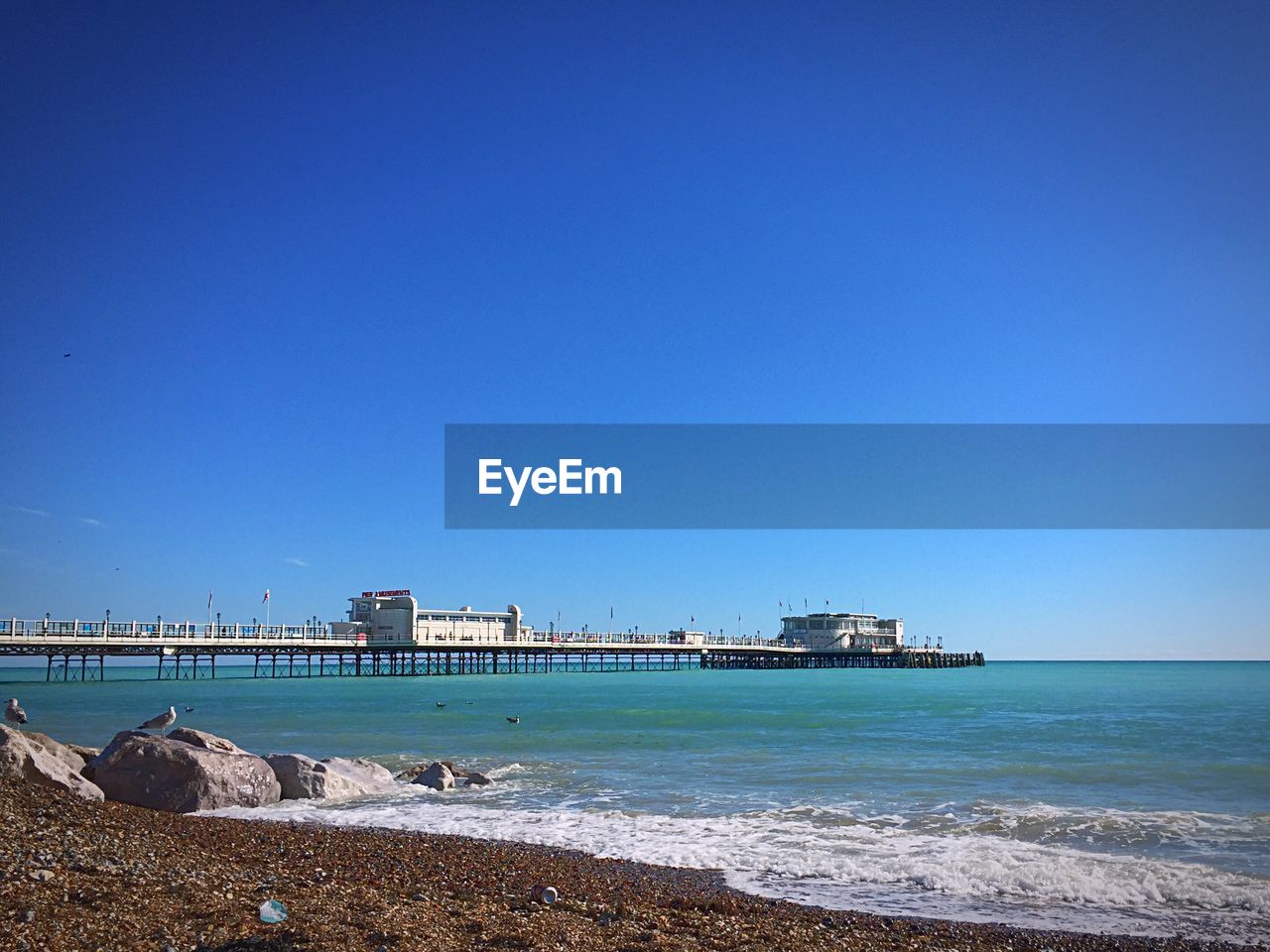 Scenic view of sea against clear blue sky