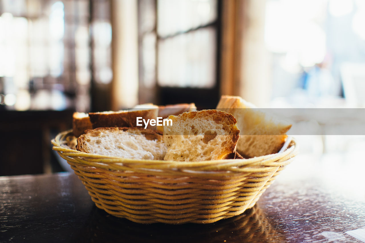 Close-up of breads in wicker basket on table