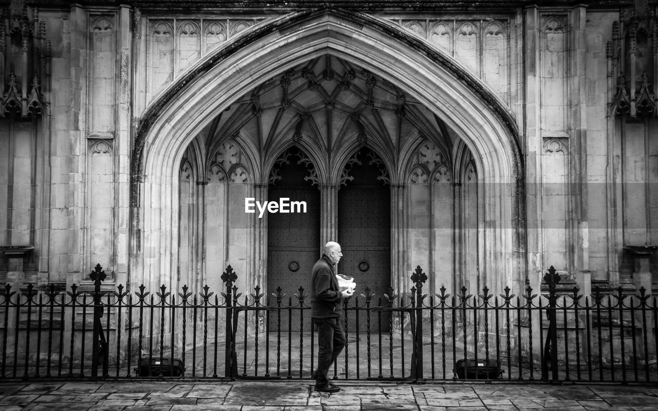 MAN STANDING AT HISTORICAL TEMPLE