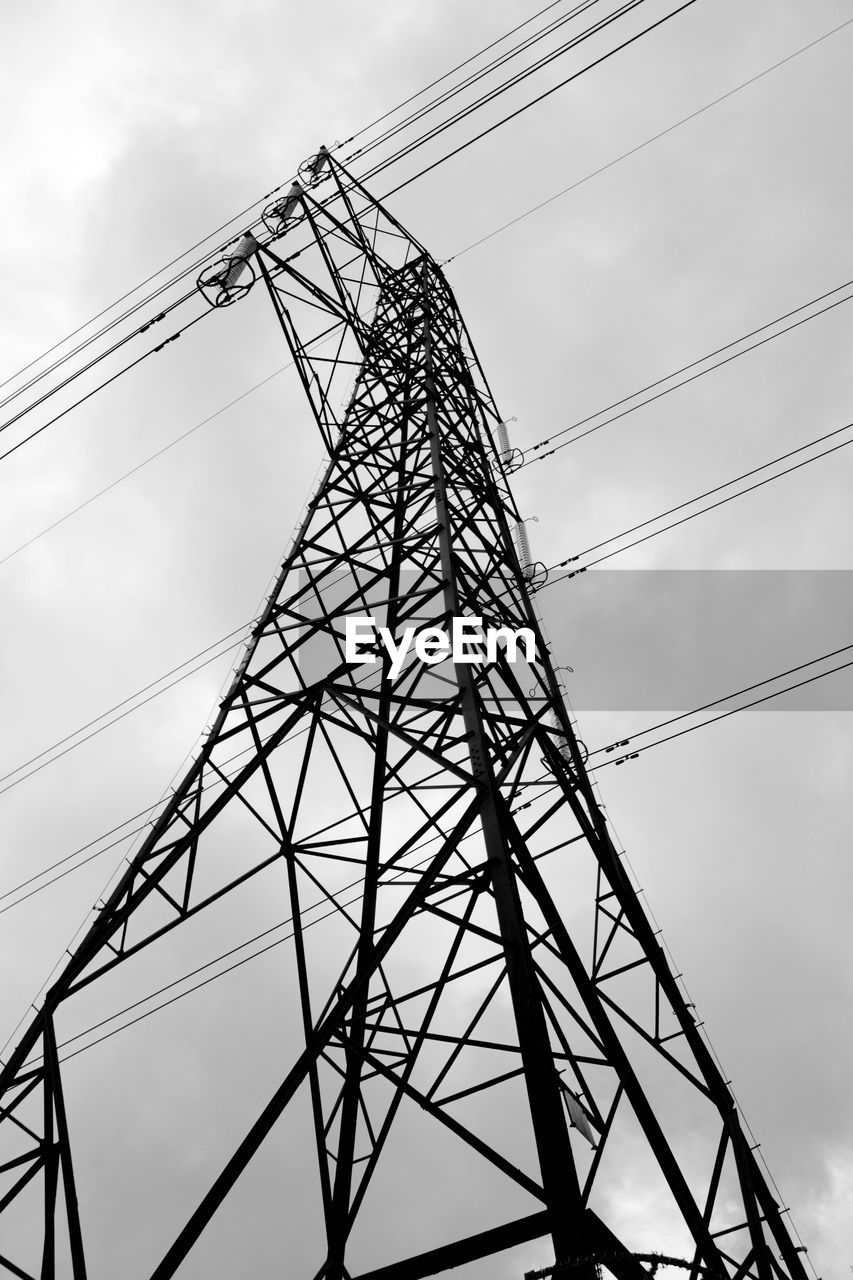 Low angle view of electricity pylon against sky