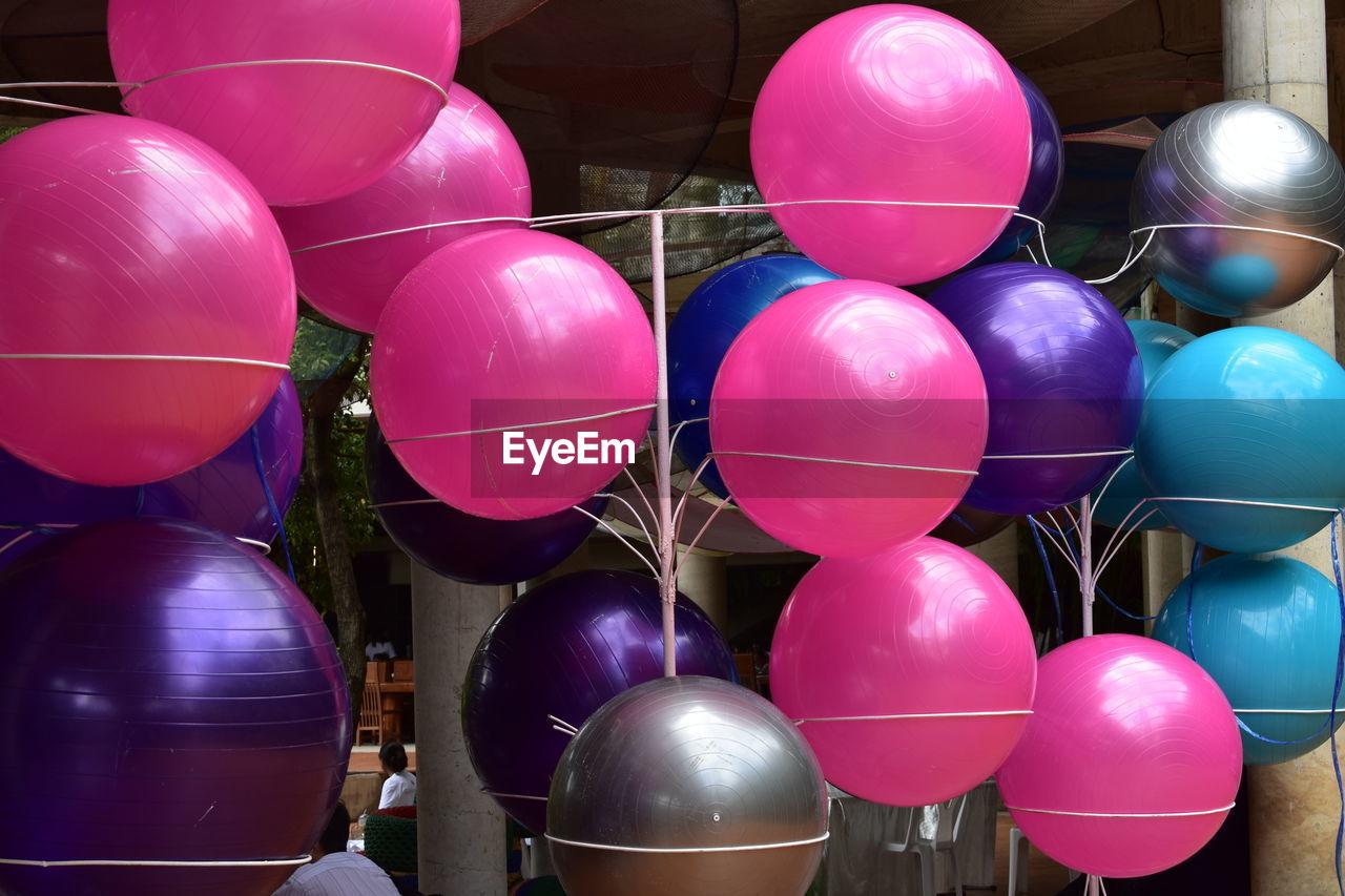 Close-up of multi colored fitness balls on rack