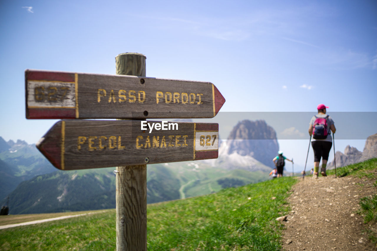 Directional sign against sky