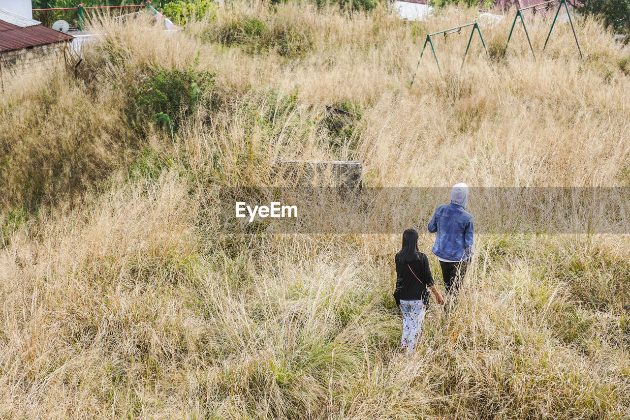 High angle view of people walking on field