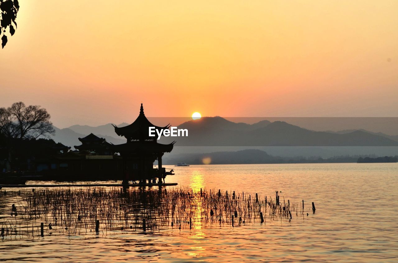 Scenic view of lake against sky during sunset