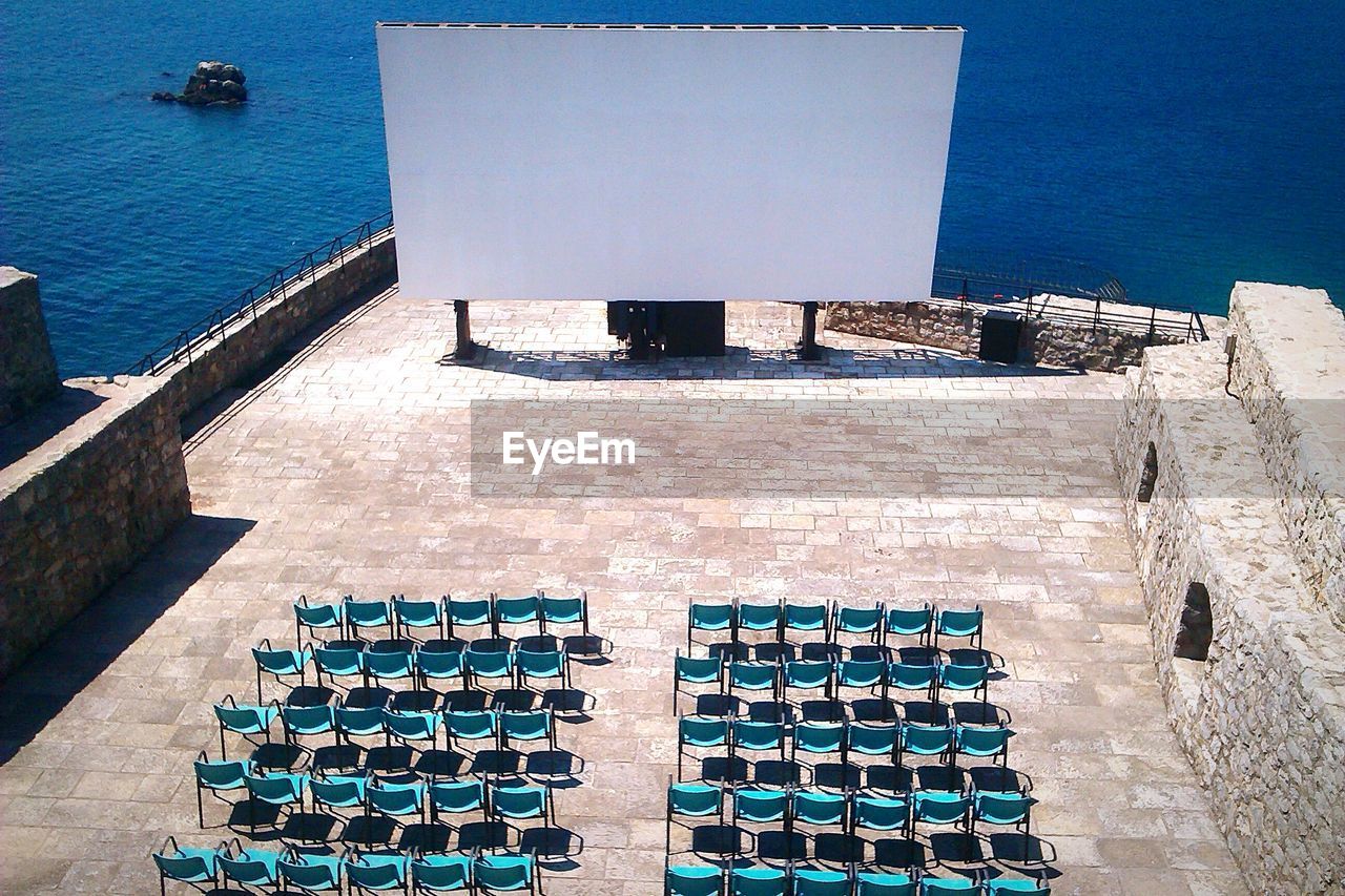 High angle view of chairs and projection screen in promenade