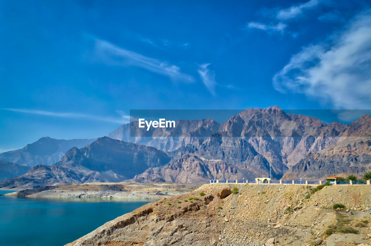 Scenic view of mountains against blue sky