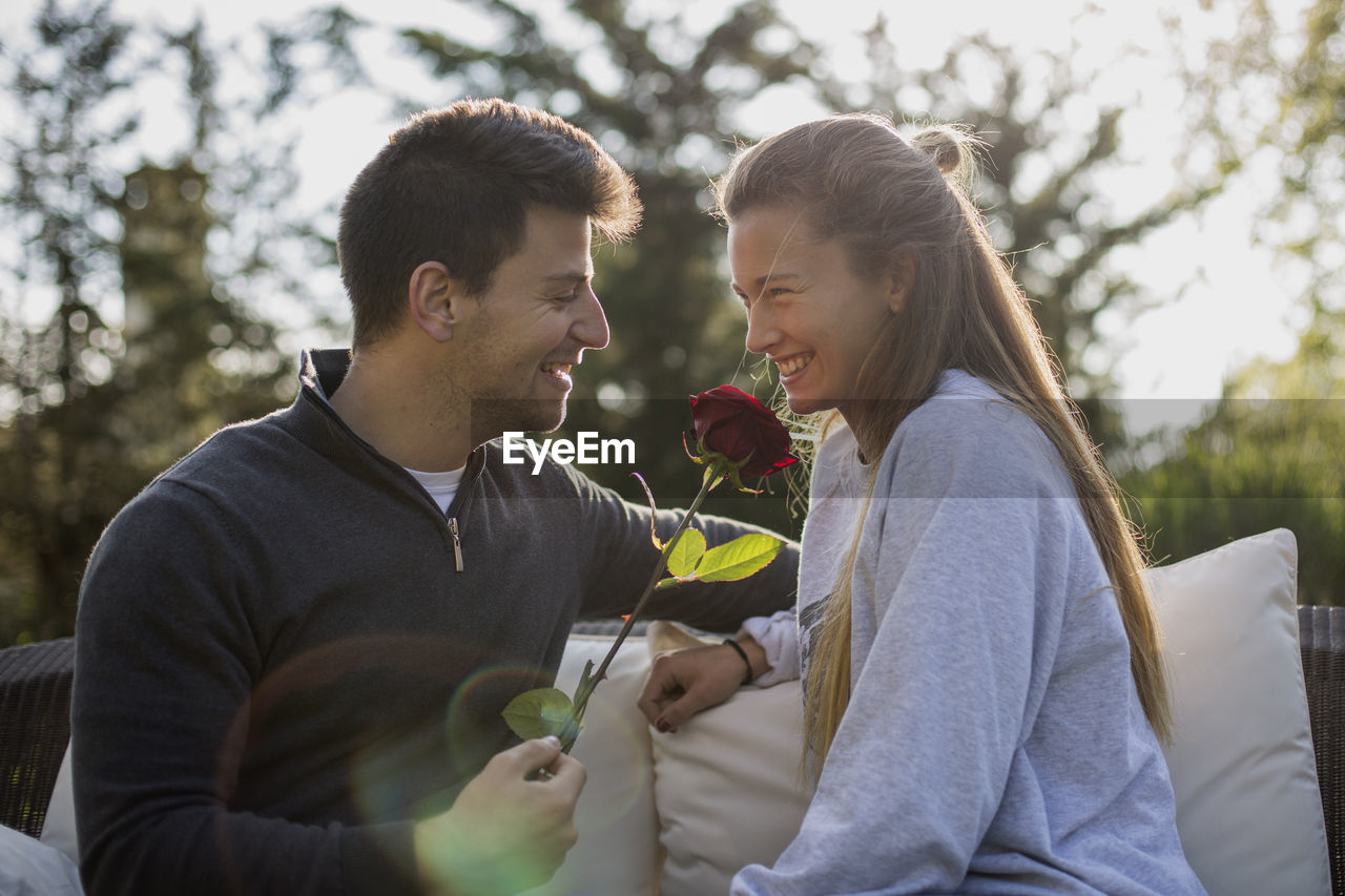 Happy couple sitting outdoors