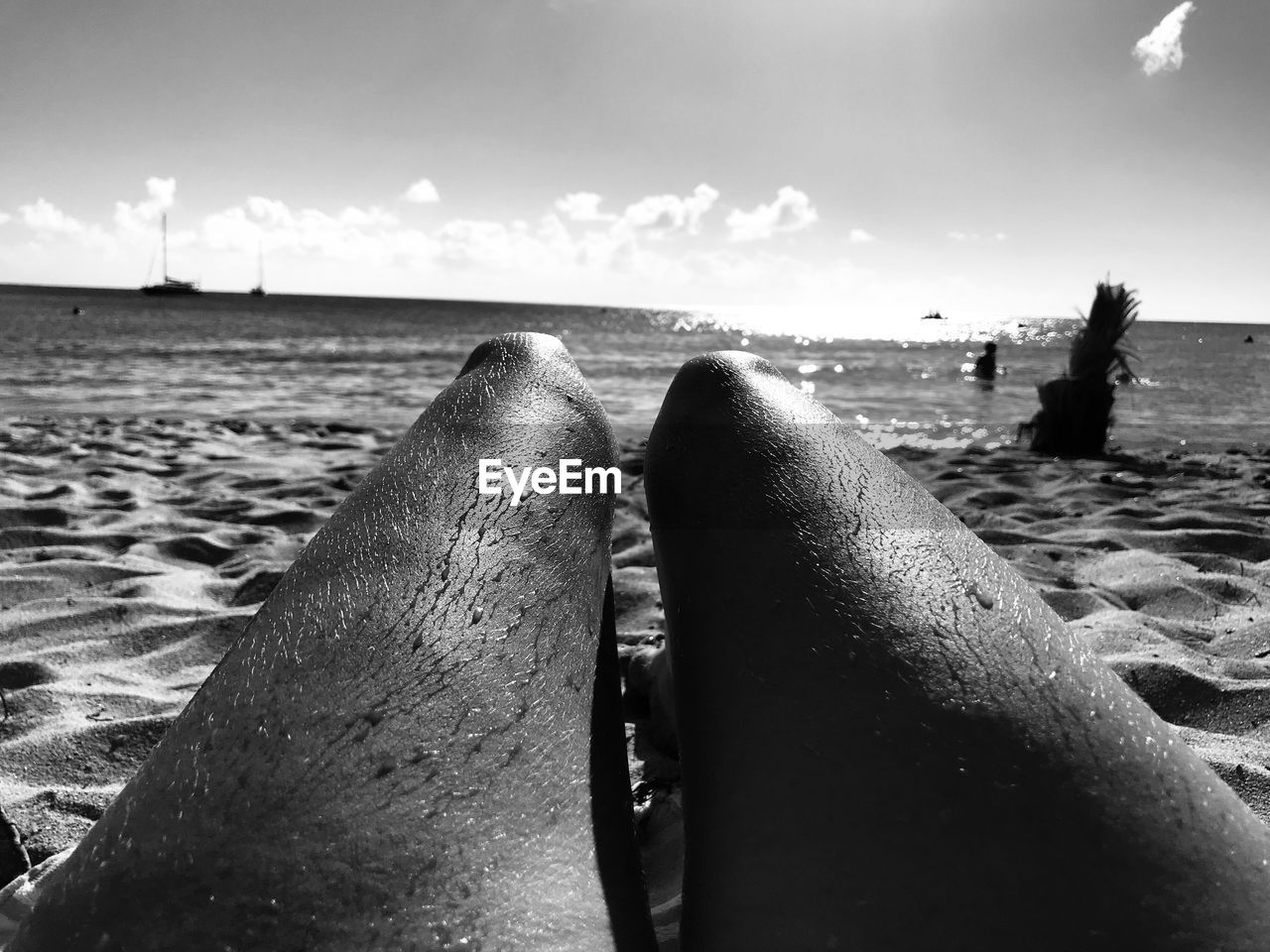 CLOSE-UP LOW SECTION OF PERSON ON BEACH