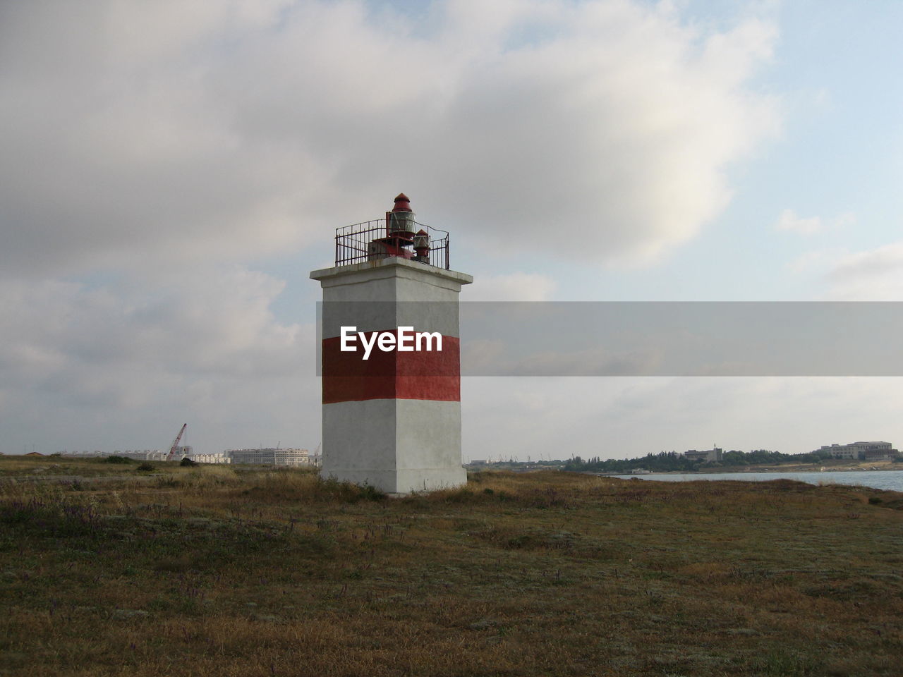 lighthouse, guidance, tower, architecture, sky, built structure, protection, security, cloud, building exterior, coast, building, sea, nature, beach, land, water, environment, day, grass, landscape, no people, outdoors, travel, coastline, travel destinations, scenics - nature, non-urban scene, communication