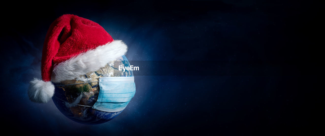 Earth with surgical mask and santa hat banner - virus infection covid 19 - world with coronavirus  
