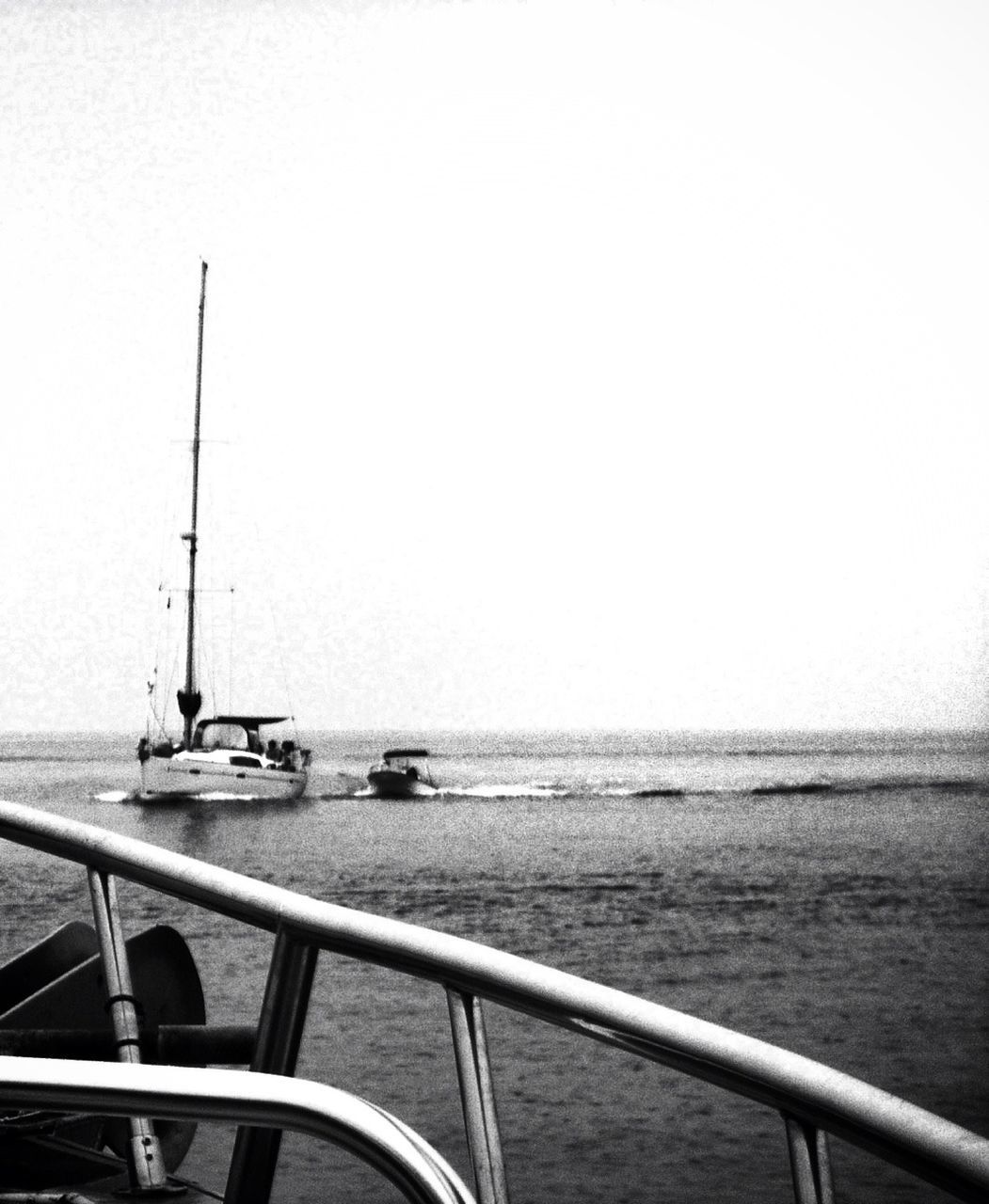 Boats in sea against clear sky