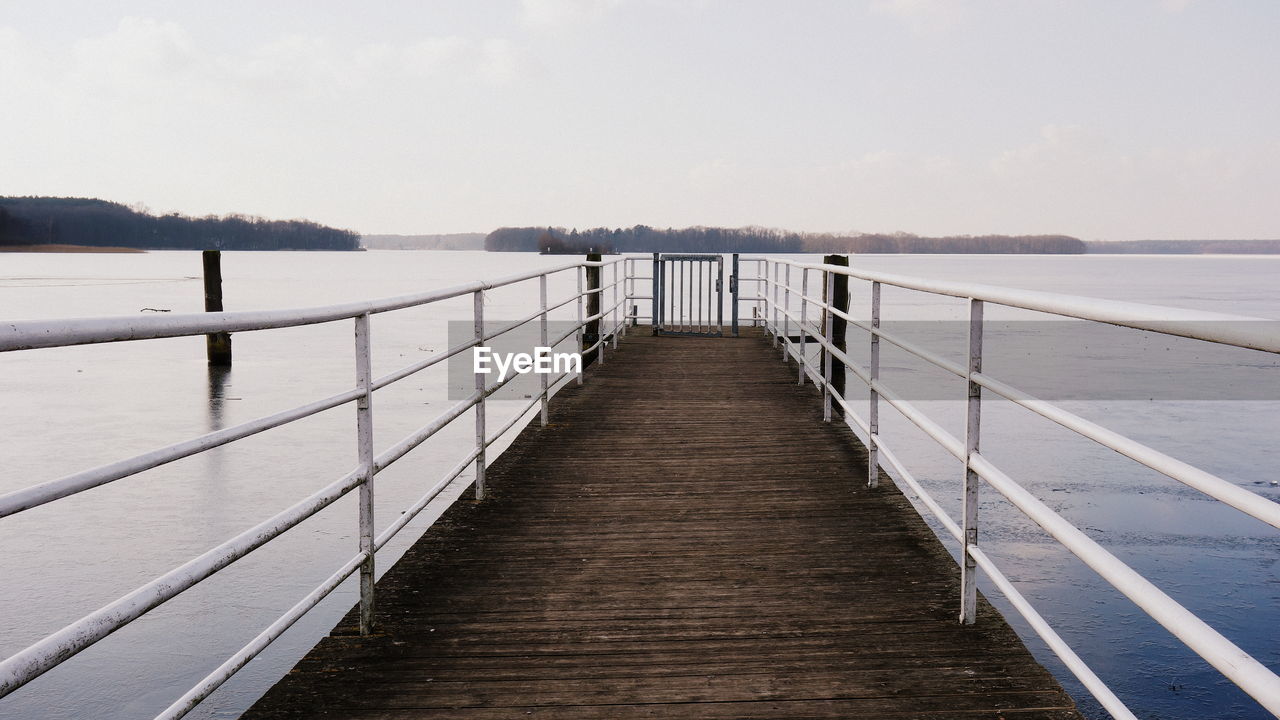 Pier over sea against sky