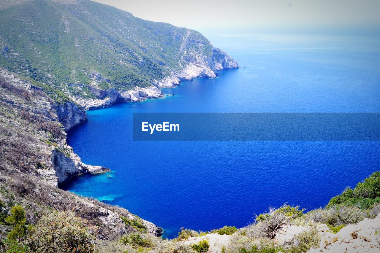 HIGH ANGLE VIEW OF SEA AND MOUNTAIN