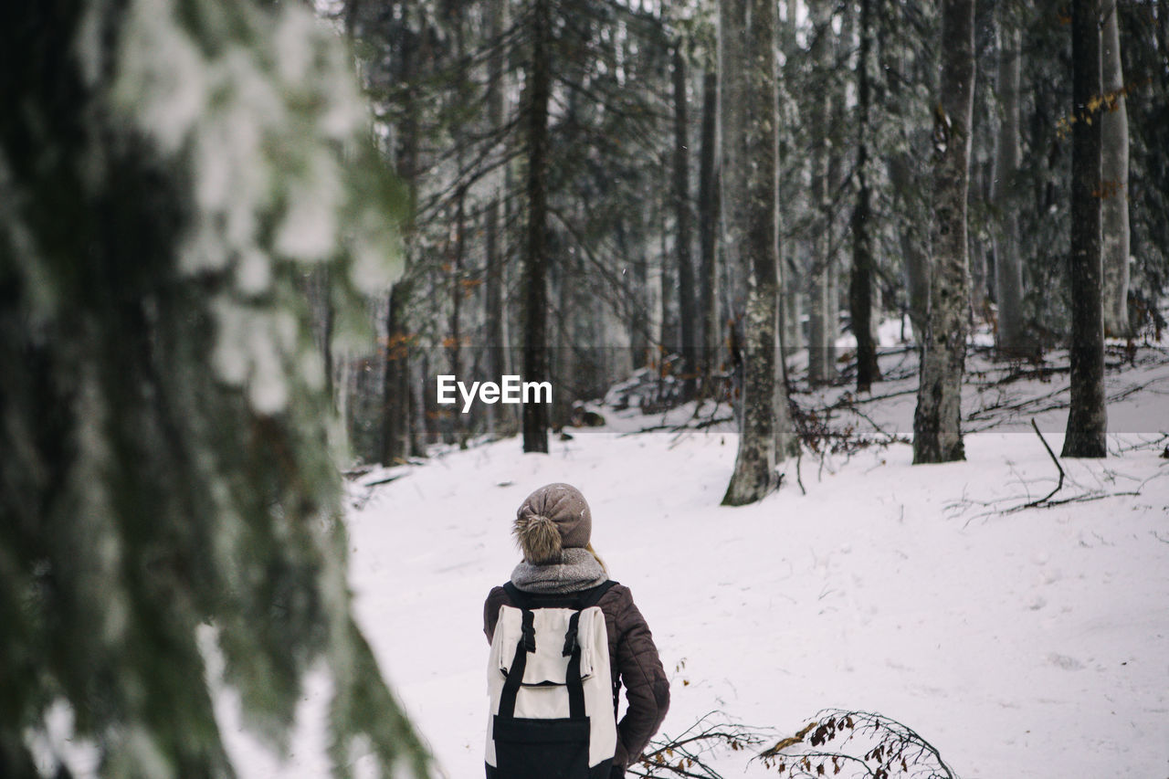 Full length of child in snow covered forest