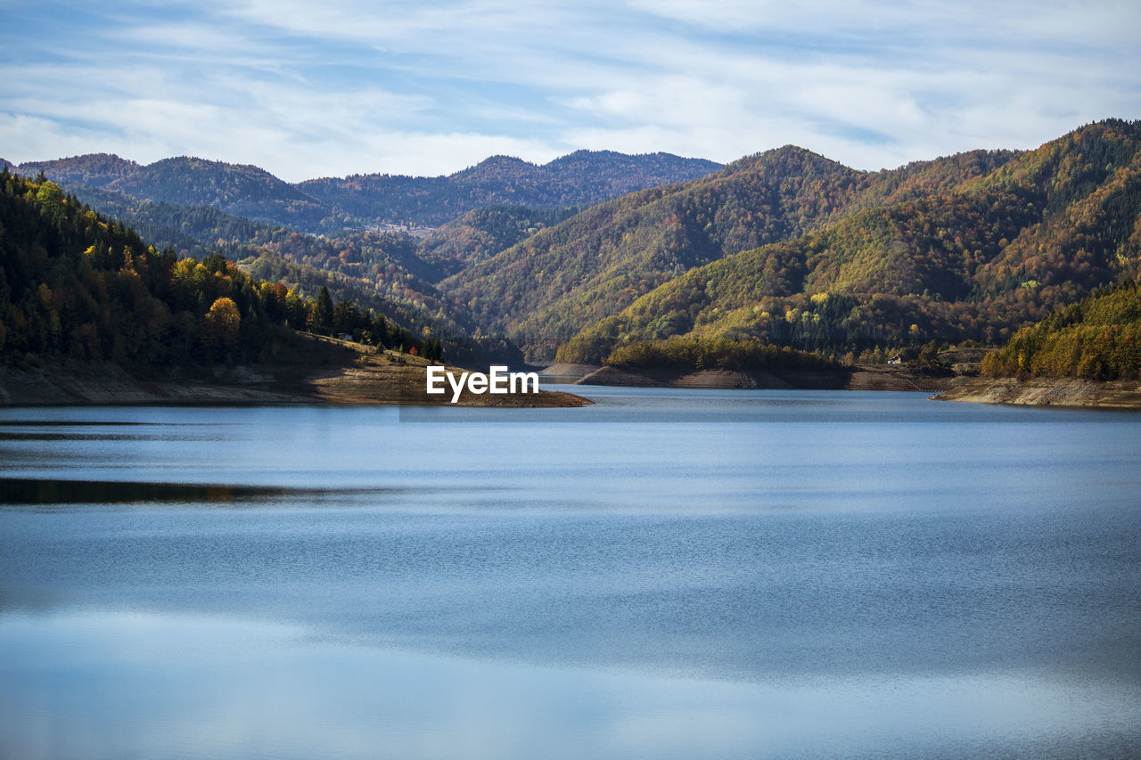 Scenic view of lake and mountains against sky