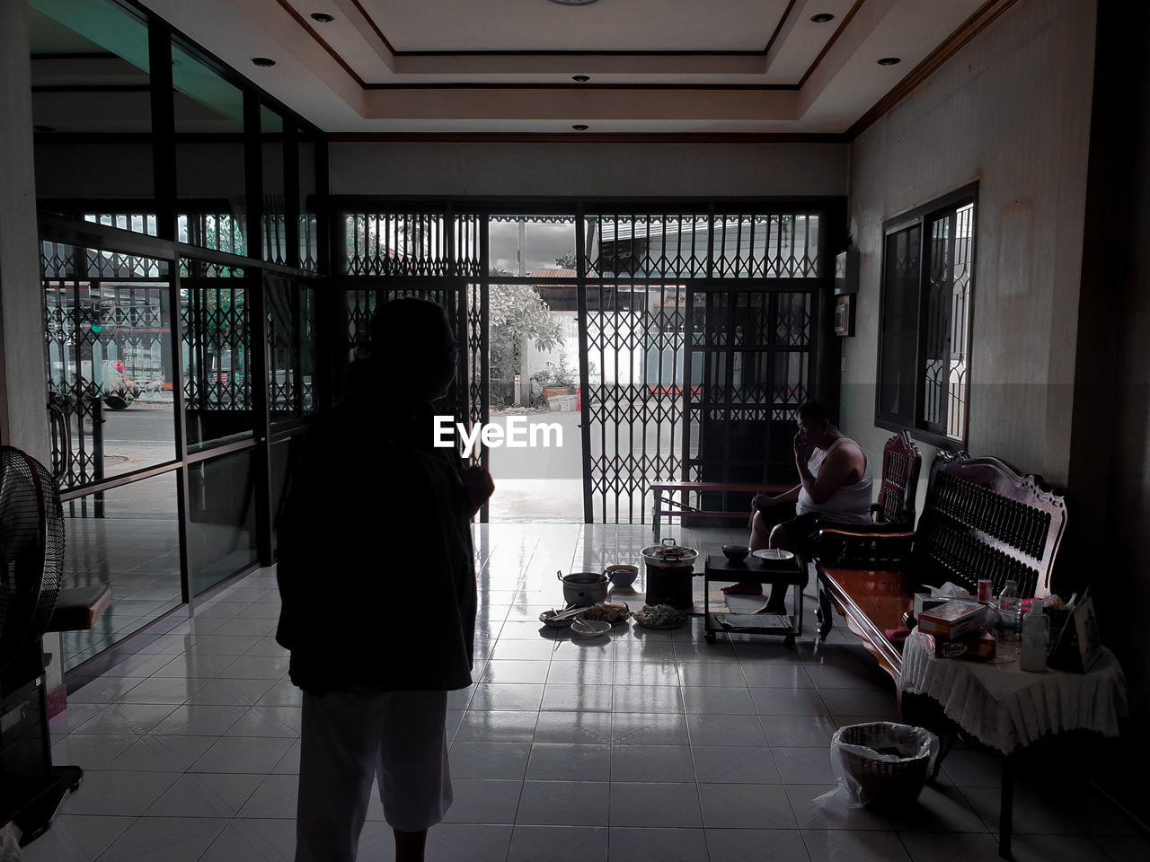 WOMAN STANDING ON TILED FLOOR