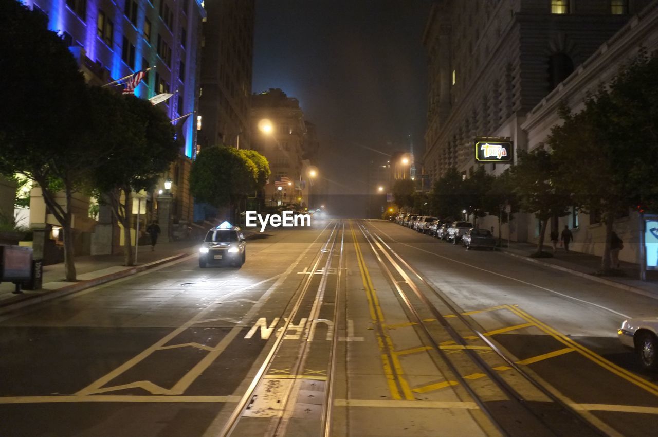 VEHICLES ON CITY STREET AT NIGHT