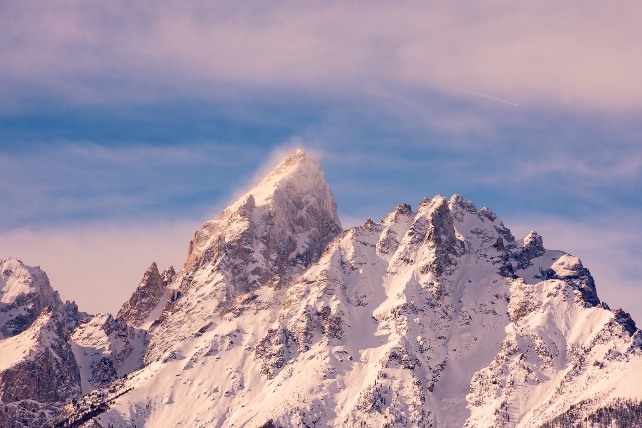 Scenic view of snow covered mountains against sky