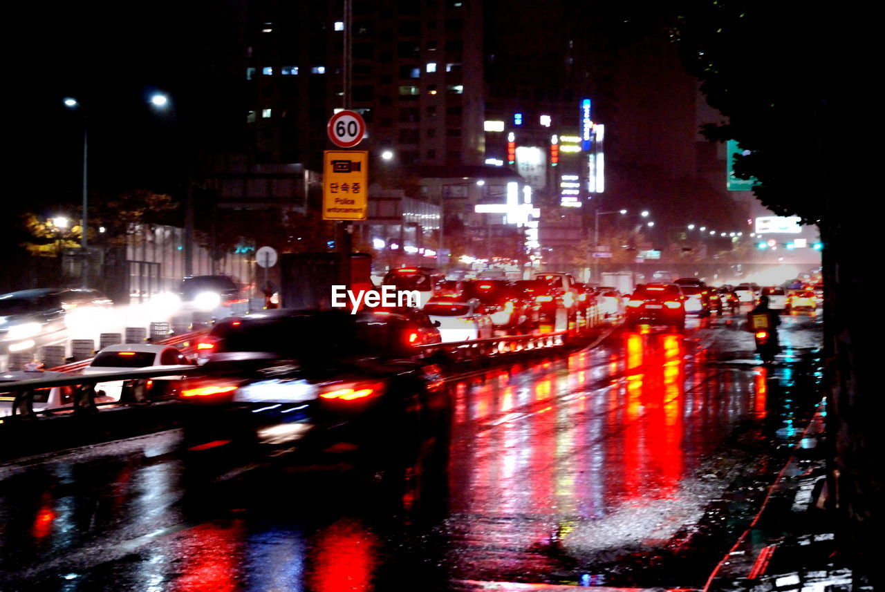 Cars on city street at night