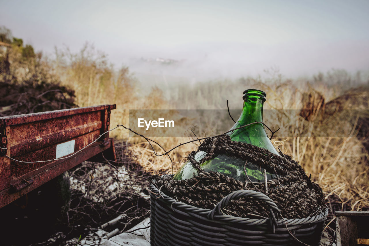 Abandoned rusty cart and jug in winter